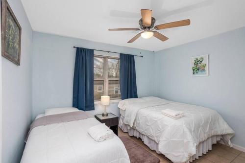 a bedroom with two beds and a ceiling fan at Quiet apartment in Iowa, LA in Iowa