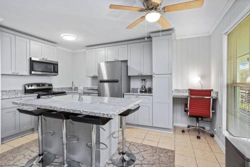 a kitchen with white cabinets and a ceiling fan at Quiet apartment in Iowa, LA in Iowa