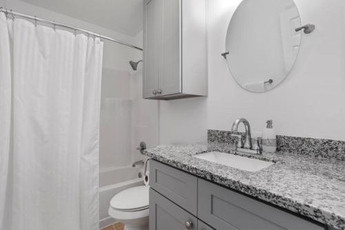 a bathroom with a sink and a toilet and a mirror at Quiet apartment in Iowa, LA in Iowa