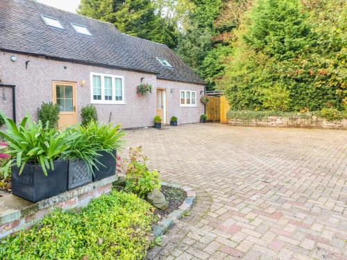 a brick driveway in front of a house at Farley Cottage I in Oakamoor
