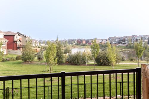 a view from a balcony of a park with houses at Orchards Retreat, AC, Family Friendly, Sleeps 10, NearAirprt in Nisku
