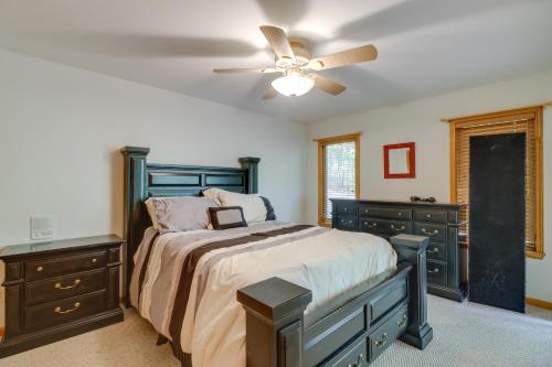 a bedroom with a bed and a ceiling fan at Fairfield Bay Retreat with Fireplaces and Lake Access in Fairfield Bay