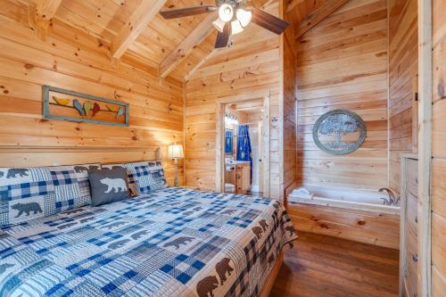 a log cabin bedroom with a bed and a tub at Ever After Mountain View Hot Tub Jetted Tub Fire Pit Great Location in Gatlinburg