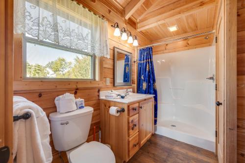 a bathroom with a toilet and a sink and a shower at Ever After Mountain View Hot Tub Jetted Tub Fire Pit Great Location in Gatlinburg