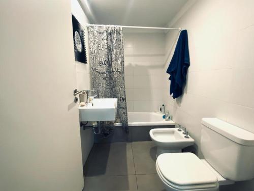 a white bathroom with a toilet and a sink at Luxury apartment in Palermo in Buenos Aires