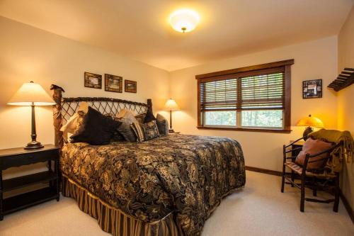a bedroom with a large bed and a window at Whiteface Mtn. Winter Adventure Getaway in Wilmington