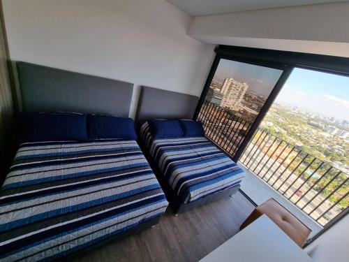 Ένα ή περισσότερα κρεβάτια σε δωμάτιο στο Hermoso apartamento por Andares con A/C