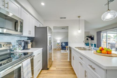a kitchen with white cabinets and a counter with fruit on a plate at Hernando Beach Waterfront Home with Boat Dock and Deck in Hernando Beach