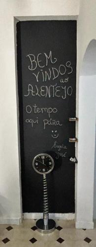 a black wall with writing on it with a stool at Mouradia Moura in Moura