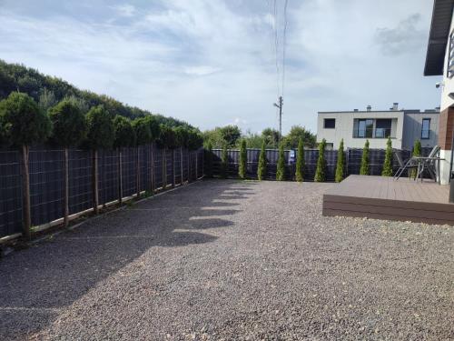 a patio with a fence and a bench in a yard at Luxury Apartments Bernardyńska Domek 1 , 2 in Kielce