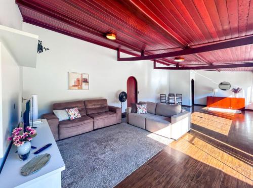 a living room with a couch and a table at Chacara com Wi-Fi e muito lazer em Guararema SP in Guararema