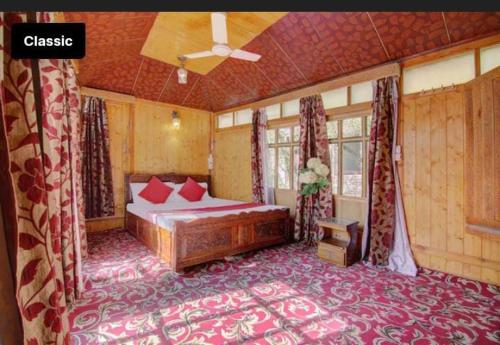 a bedroom with a bed and a ceiling at Gulbahaar Group Of HouseBoats in Srinagar