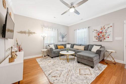 a living room with a couch and a table at * Lux Modern Retreat * Downtown * King Beds * in Durham
