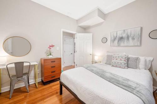 a bedroom with a bed and a desk and a mirror at * Lux Modern Retreat * Downtown * King Beds * in Durham
