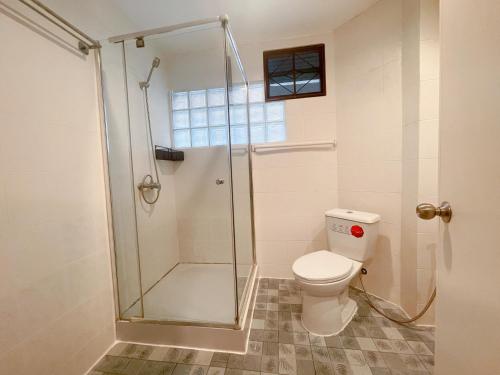 a bathroom with a toilet and a glass shower at Patong Beach - Private Pool Villa in Patong Beach