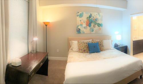 a bedroom with a large bed and a table at Midtown Quarters- Spacious 2bd 2ba, Private Balcony -S55 in Atlanta
