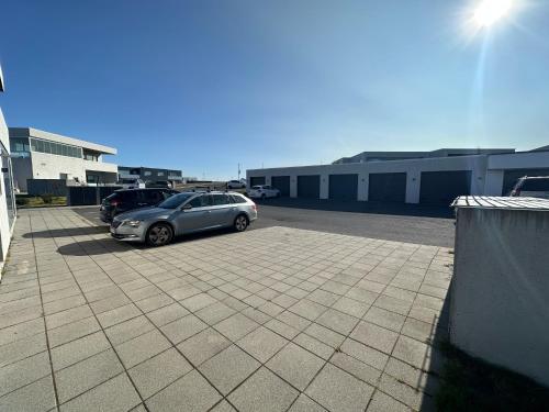 a car parked in a parking lot next to a building at Apartment in Austurkór- Birta Rentals in Reykjavík