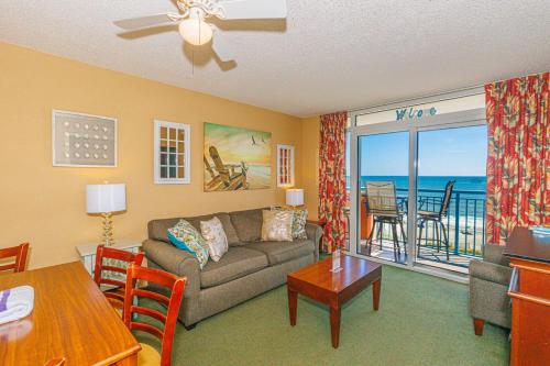 a living room with a couch and a table at Spacious Oceanfront 2 Bedroom Suite - Sleeps 8! - Roxanne Towers Unit 406 in Myrtle Beach