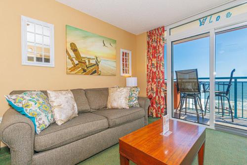 a living room with a couch and a table at Spacious Oceanfront 2 Bedroom Suite - Sleeps 8! - Roxanne Towers Unit 406 in Myrtle Beach