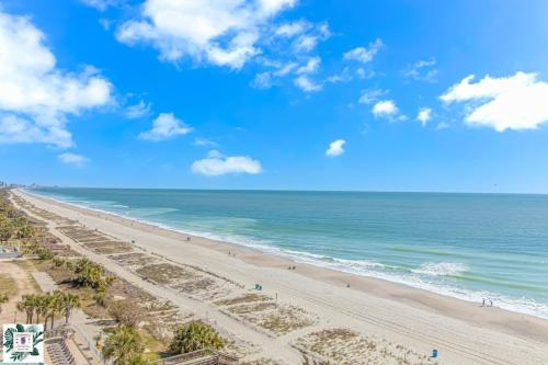 a view of the beach from the balcony of a resort at Spacious Oceanfront 2 Bedroom Suite - Sleeps 8! - Roxanne Towers Unit 406 in Myrtle Beach