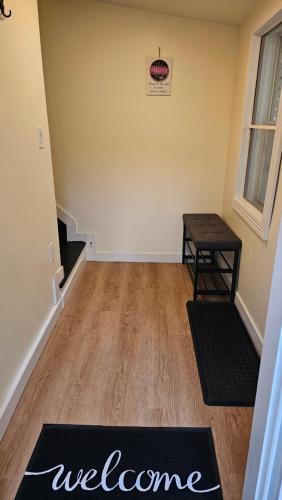 a living room with a welcome mat on the floor at Serenity Getaway in Halifax