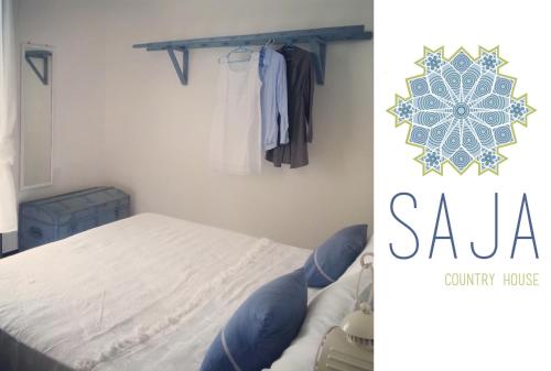 a bedroom with a bed and a clothes rack at Saja Country House in Acireale