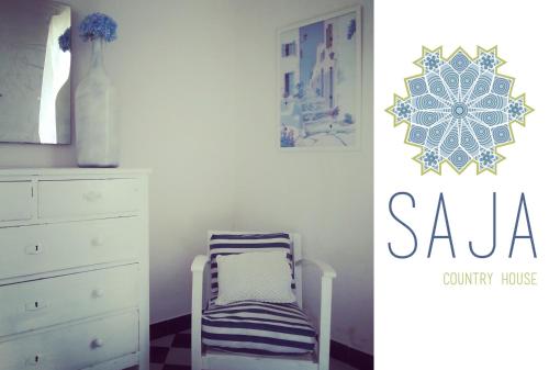 a room with a chair next to a dresser at Saja Country House in Acireale
