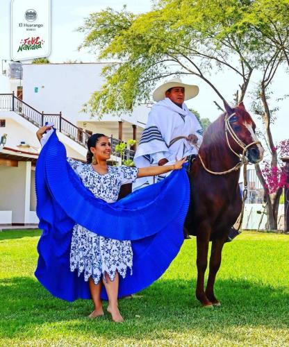 a man riding on a horse with a woman at Bodega el Huarango in Ica