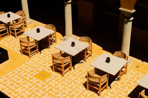 a group of tables and chairs on a floor at Hotel Casona Oaxaca in Oaxaca City