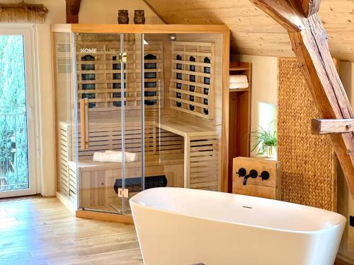 a bath tub in a room with a wine cellar at Igelnest Großthiemig in Großthiemig