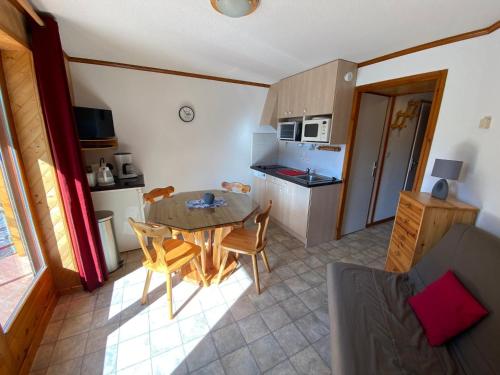 a kitchen and dining room with a table and chairs at Studio charmant à Châtel avec Multi Pass offert, à quelques minutes du centre-ville ! - FR-1-693-23 in Châtel