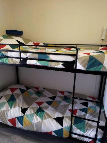 two bunk beds in a room with colorful at Studio au cœur de Quiberon in Quiberon