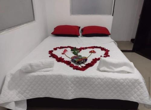 a bed with a heart made out of flowers at Hotel Bogotá Suites in Bogotá