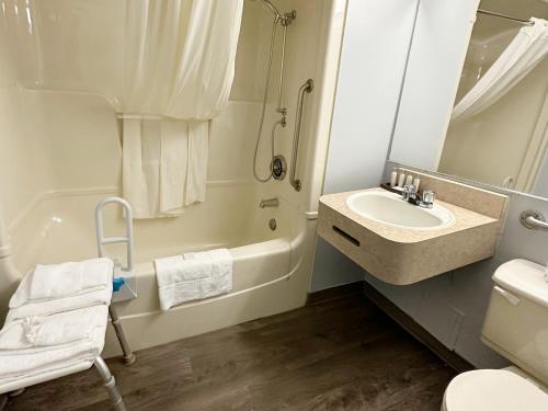 a bathroom with a sink and a toilet and a shower at Travelodge by Wyndham Welland in Welland