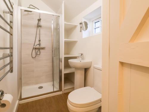 a bathroom with a toilet and a shower at The Stable in Lyme Regis