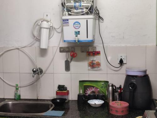 a kitchen counter with a sink and a mixer at Aayushman Homes in Bangalore