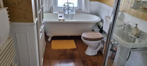 a small bathroom with a toilet and a sink at Millstream House in Winchester