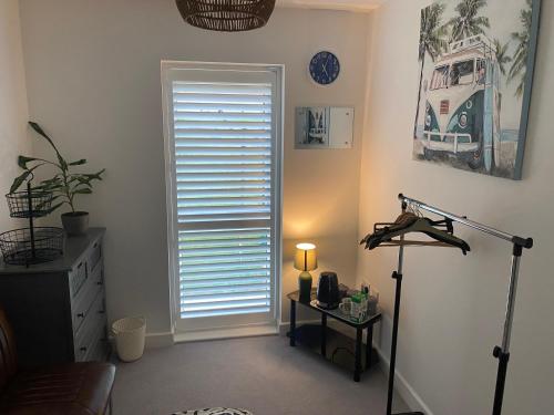 a room with a door and a table with a lamp at Double room to rent in Newhaven