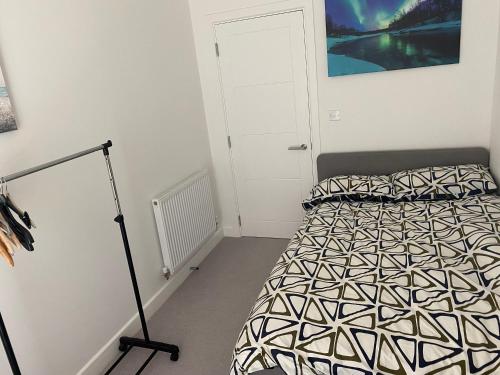 a bedroom with a bed with a black and white comforter at Double room to rent in Newhaven