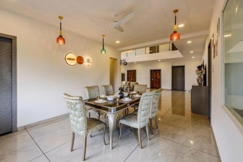 a dining room with a table and chairs at SaffronStays Ivory Mansion in Pen