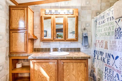 a bathroom with a sink and a mirror at Oak Harbor on Lake of the Woods & Rainy River in Baudette