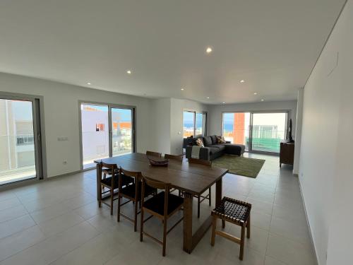 a living room with a table and a couch at Luxury flat with ocean view Nazaré Sitio in Nazaré