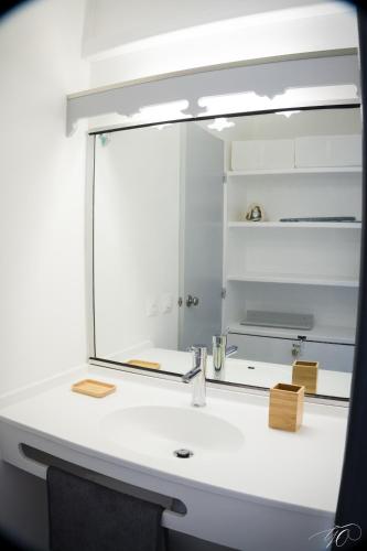 a mirror over a sink in a bathroom at Studio GAP in Le Diamant