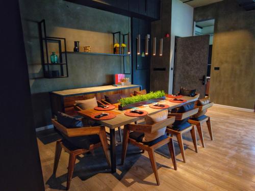 a dining room with a wooden table and chairs at VAUX Park Street Hotel - A collection of 8 luxury lofts in Colombo