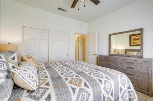 een slaapkamer met een bed, een dressoir en een spiegel bij Serene Surprise Vacation Home with Patio - Near Golf in Surprise