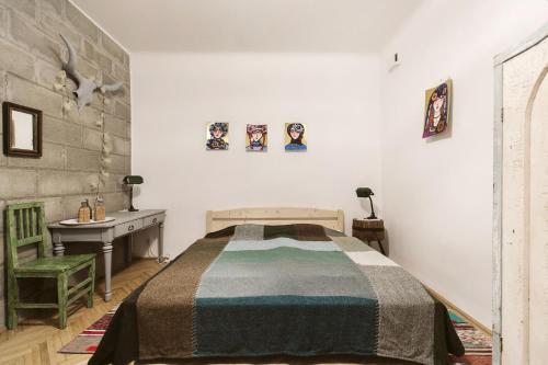a bedroom with a bed and a desk in it at The Double Vintage & Handcrafted in Budapest