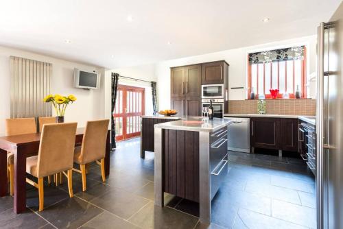 a kitchen with a table and a dining room at Super Spacious Country house pet/party friendly. in Newquay