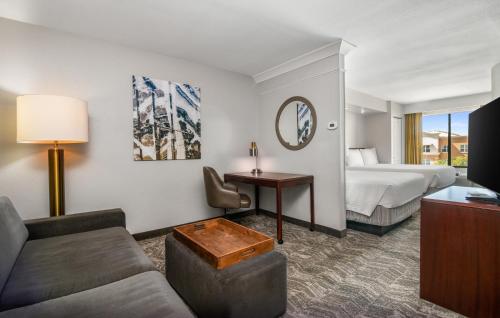 a hotel room with a bed and a couch at SpringHill Suites Phoenix Glendale Sports & Entertainment District in Glendale