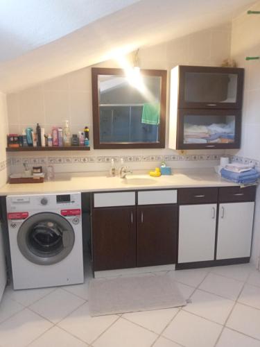 a kitchen with a sink and a washing machine at Paradise Manavgat in Manavgat