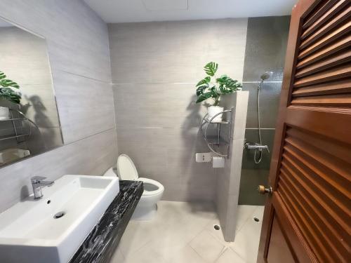 a bathroom with a white sink and a toilet at Thonglor 25 Classic Home 5BR/7Beds/14PPL in Ban Na Song